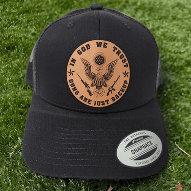 In God We Trust, Guns Are Just Backup Leather Patch Trucker Hat - Trucker Hat - Charm and Char